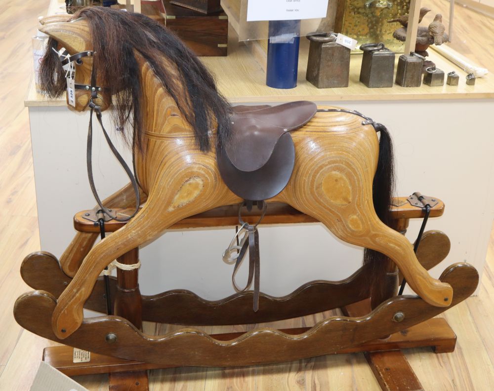 An Ian Armstrong carved rocking horse with brown leather tack